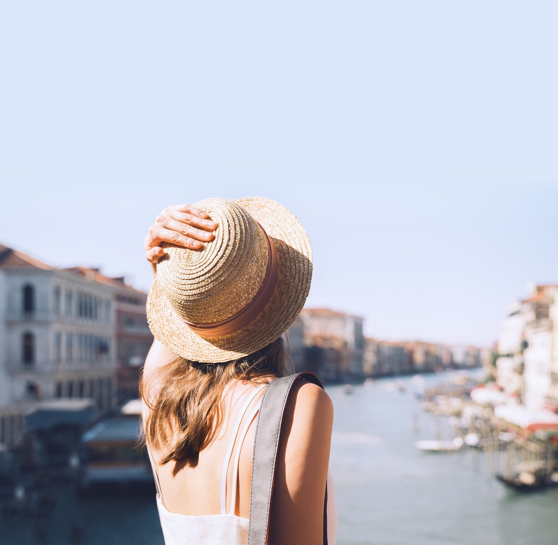 Young woman travel Italy. Vacation in Europe. Girl enjoy beautiful view in Venice.